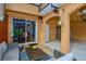 Covered patio with seating and access to garage at 1933 Island Walk Dr, Orlando, FL 32824
