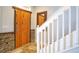Interior view of a staircase with wooden railing and stone accent wall at 1933 Island Walk Dr, Orlando, FL 32824