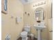Clean bathroom with pedestal sink, toilet and floor tile at 220 Brunello Dr, Davenport, FL 33897