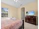 Bedroom with a queen-size bed, dresser and TV at 220 Brunello Dr, Davenport, FL 33897
