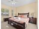 Main bedroom with king-size bed, nightstands and window at 220 Brunello Dr, Davenport, FL 33897