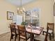 Charming dining room with wooden table, chairs, and a chandelier at 220 Brunello Dr, Davenport, FL 33897