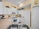 Bright kitchen with white cabinets, stainless steel appliances, and a double sink at 220 Brunello Dr, Davenport, FL 33897
