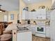 Kitchen with white cabinets, tile floors, and stainless steel appliances at 220 Brunello Dr, Davenport, FL 33897