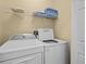 Laundry room with washer, dryer, and shelving at 220 Brunello Dr, Davenport, FL 33897