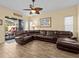 Spacious living room with large sectional sofa and tile floors at 220 Brunello Dr, Davenport, FL 33897