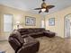Relaxing living room featuring a brown leather sectional sofa at 220 Brunello Dr, Davenport, FL 33897