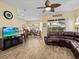 Spacious living room featuring a large brown sectional sofa and tile floors at 220 Brunello Dr, Davenport, FL 33897
