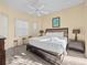 Main bedroom with king-size bed, dark wood furniture, and ceiling fan at 220 Brunello Dr, Davenport, FL 33897