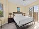 Bright bedroom with a king-size bed and sliding glass doors to patio at 220 Brunello Dr, Davenport, FL 33897