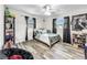 Cozy bedroom with a double bed and wood-look flooring at 2219 Pilaklakaha Ave, Auburndale, FL 33823