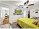 Bedroom with mustard bedding and a large TV at 2219 Pilaklakaha Ave, Auburndale, FL 33823
