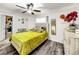 Bedroom with a yellow comforter and ceiling fan at 2219 Pilaklakaha Ave, Auburndale, FL 33823