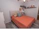 Bedroom with coral bedding and decorative shelves at 2219 Pilaklakaha Ave, Auburndale, FL 33823