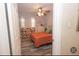 Bedroom with orange bedding and ceiling fan at 2219 Pilaklakaha Ave, Auburndale, FL 33823