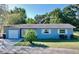 Cute ranch home with a grey exterior, nicely landscaped yard, and driveway at 2219 Pilaklakaha Ave, Auburndale, FL 33823