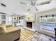 Gathering room with fireplace, pool view, and lots of natural light at 2219 Pilaklakaha Ave, Auburndale, FL 33823