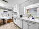 White kitchen with stainless steel appliances and view to backyard at 2219 Pilaklakaha Ave, Auburndale, FL 33823