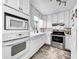 White kitchen with stainless steel appliances and ample counter space at 2219 Pilaklakaha Ave, Auburndale, FL 33823