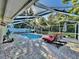 Relaxing screened pool area with lounge chairs and patio at 2219 Pilaklakaha Ave, Auburndale, FL 33823
