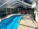 Relaxing screened pool and patio with lounge chairs at 2219 Pilaklakaha Ave, Auburndale, FL 33823