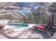 Sunny screened pool area with lounge chairs and patio furniture at 2219 Pilaklakaha Ave, Auburndale, FL 33823