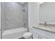 Bathroom with white vanity, granite countertop and a bathtub at 223 Elm Ct, Kissimmee, FL 34759