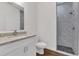 Clean bathroom with white vanity, granite countertop and a shower at 223 Elm Ct, Kissimmee, FL 34759