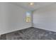 Bright bedroom featuring grey carpet and a window at 223 Elm Ct, Kissimmee, FL 34759