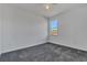 Bright bedroom featuring grey carpet and a window at 223 Elm Ct, Kissimmee, FL 34759