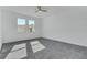 Spacious bedroom with grey carpet and large windows at 223 Elm Ct, Kissimmee, FL 34759