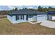 Newly built home with light blue exterior, two-car garage, and landscaping at 223 Elm Ct, Kissimmee, FL 34759