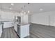 Modern kitchen with white cabinets, granite countertops, and island at 223 Elm Ct, Kissimmee, FL 34759