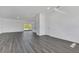 Open living room with gray vinyl plank flooring and kitchen access at 223 Elm Ct, Kissimmee, FL 34759
