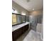 Bathroom with granite countertops, double sinks, and a large shower at 2438 Yellow Brick Rd, St Cloud, FL 34772