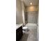 Clean bathroom with tub shower, granite countertop, and dark brown vanity at 2438 Yellow Brick Rd, St Cloud, FL 34772