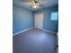 Light-blue bedroom with ceiling fan and double door closet at 2438 Yellow Brick Rd, St Cloud, FL 34772