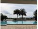 Inviting community pool with palm trees and lounge chairs at 2438 Yellow Brick Rd, St Cloud, FL 34772