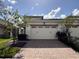 Two-car garage with brick paver driveway at 2438 Yellow Brick Rd, St Cloud, FL 34772