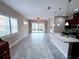 Open floor plan living room with tile floors and sliding glass doors at 2438 Yellow Brick Rd, St Cloud, FL 34772