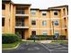 A condo building featuring an accessible parking spot, shrubbery, and multiple balconies at 3004 Parkway Blvd # 208, Kissimmee, FL 34747