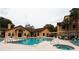 Resort-style pool and hot tub with lounge chairs and umbrella-covered tables for relaxation at 3004 Parkway Blvd # 208, Kissimmee, FL 34747