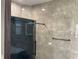 Modern bathroom featuring a tiled shower with a glass door, with sleek fixtures and neutral tones at 3034 Boating Blvd, Kissimmee, FL 34746