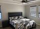 Cozy bedroom featuring a comfortable bed, two windows, and stylish window treatments at 3034 Boating Blvd, Kissimmee, FL 34746