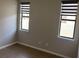 A simple, clean bedroom with two windows, tile floors, and neutral paint at 3034 Boating Blvd, Kissimmee, FL 34746