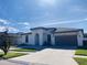 Beautiful single-story home boasts a neutral exterior, an arched entryway, and a well-manicured lawn at 3034 Boating Blvd, Kissimmee, FL 34746