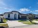 Stunning exterior view of this single-story home featuring a clean color palette and a neatly landscaped yard at 3034 Boating Blvd, Kissimmee, FL 34746