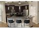 Modern kitchen with dark wood cabinets, stainless steel appliances, pendant lighting, and breakfast bar at 3034 Boating Blvd, Kissimmee, FL 34746