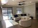 Bright living room featuring a large sectional sofa, tile floors, and sliding glass doors to the pool at 3034 Boating Blvd, Kissimmee, FL 34746