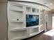 Living room featuring a custom media center with recessed lighting and decorative niches at 3034 Boating Blvd, Kissimmee, FL 34746